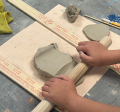 Someone rolling clay 