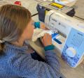 A child sewing on a sewing machine.