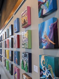 Picture shows canvases from a previous Four Eights exhibit show on the gallery walls. 