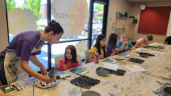 Painting instructor teaching children how to paint