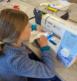 A child sewing on a sewing machine.