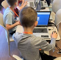 A kid programming on a laptop.